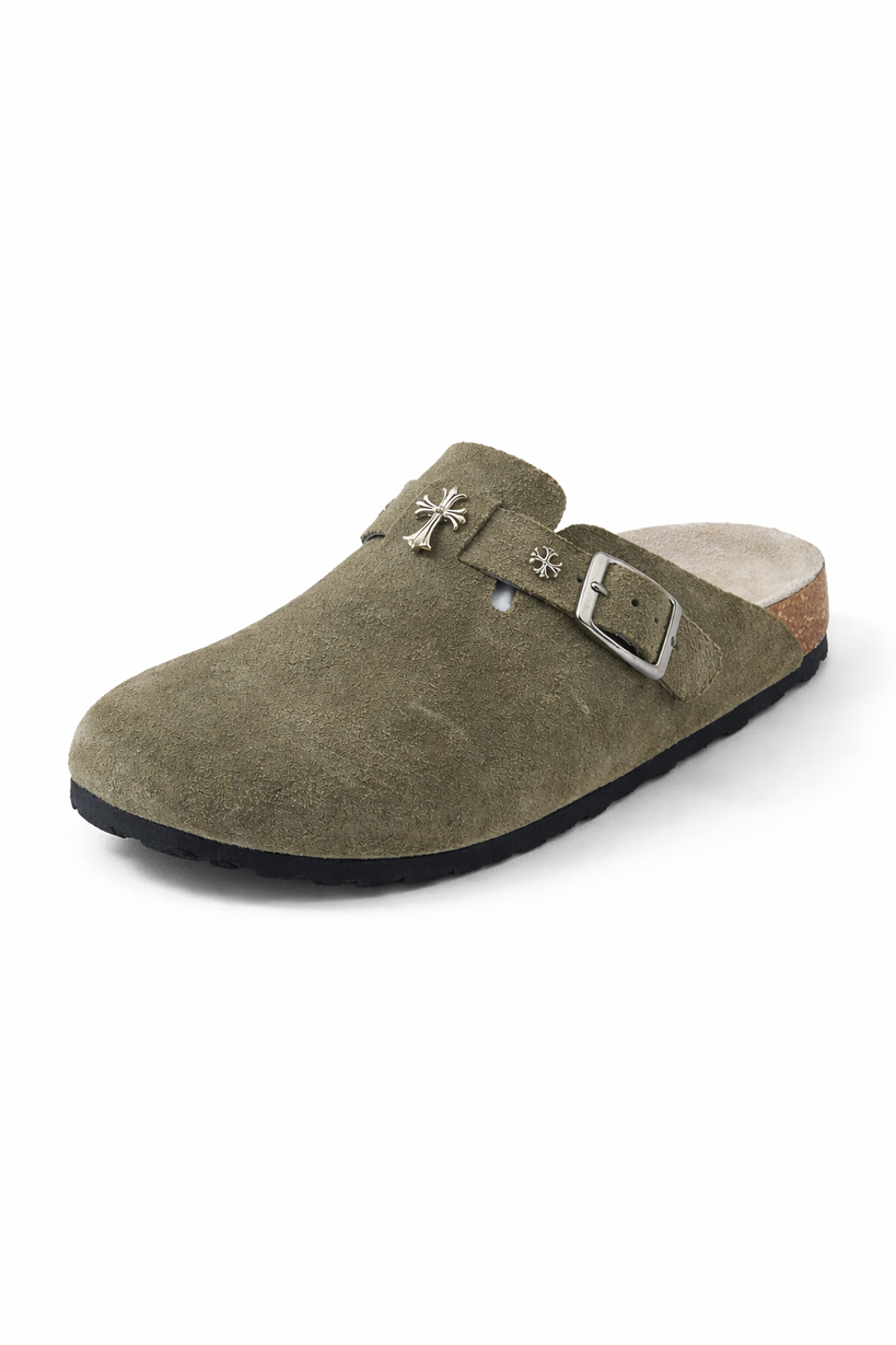 Green suede clog shoe with a buckle on a white background
