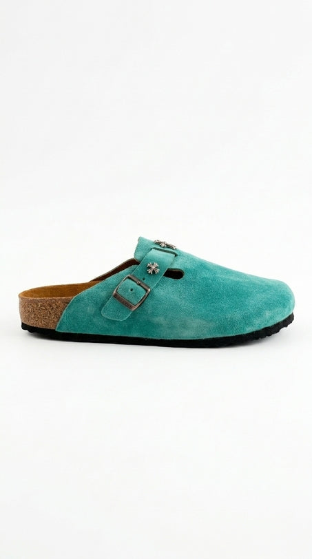 Turquoise suede clog shoe on a white background